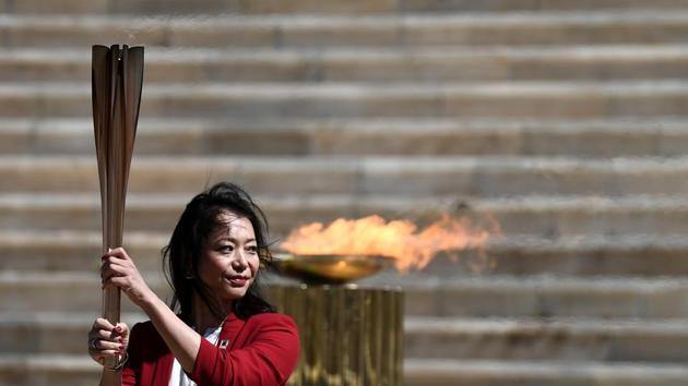 Former Japanese swimmer Imoto Naoko holds the Olympic torch. (REUTERS) Former Japanese swimmer Imoto Naoko holds the Olympic torch. (REUTERS)