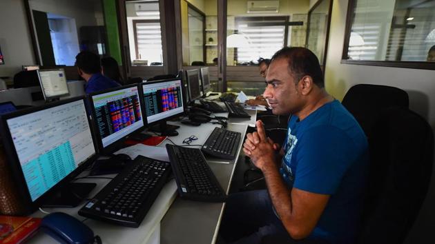 Traders monitor BSE index at a brokerage firm (PTI File) Traders monitor BSE index at a brokerage firm (PTI File)