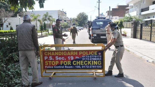 Chandigarh Police personnel cordoning off the street where the 23-year-old woman lives in Sector 21, Chandigarh, on Thursday. (Ravi Kumar) Chandigarh Police personnel cordoning off the street where the 23-year-old woman lives in Sector 21, Chandigarh, on Thursday. (Ravi Kumar)