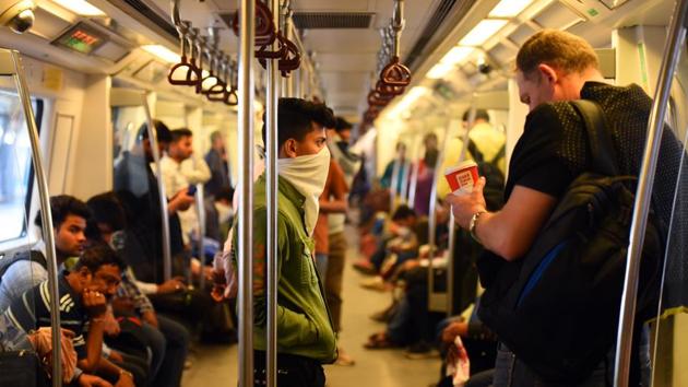 Commuters wearing face masks as a precautionary measure against coronavirus infections, at Rajiv Chowk Metro Station in New Delhi, India, on Friday, March 20, 2020. (Raj K Raj/HT photo) Commuters wearing face masks as a precautionary measure against coronavirus infections, at Rajiv Chowk Metro Station in New Delhi, India, on Friday, March 20, 2020. (Raj K Raj/HT photo)