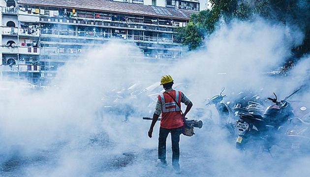 A worker carries out fumigation at Grant Road in Mumbai on January 15. A worker carries out fumigation at Grant Road in Mumbai on January 15.