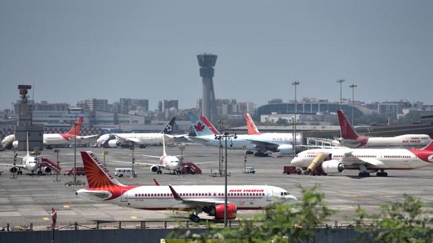 Aeroplanes are seen parked at the Mumbai airport on Saturday, March 21. The Indian government on Thursday banned commercial international airlines to operate to India for a week from 22 March, following an effort to curb the outspread of COVID-19, which has already seen the country temporarily ban foreigners from entering it. (Satish Bate / HT Photo) Aeroplanes are seen parked at the Mumbai airport on Saturday, March 21. The Indian government on Thursday banned commercial international airlines to operate to India for a week from 22 March, following an effort to curb the outspread of COVID-19, which has already seen the country temporarily ban foreigners from entering it. (Satish Bate / HT Photo)