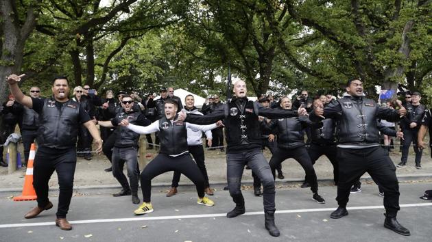 Members of the Tu Tangata motorcycle club perform a haka outside the Al Noor mosque in Christchurch, New Zealand on March 15. A national memorial to commemorate the 51 people who were killed last year when a gunman attacked two mosques has been cancelled due to coronavirus concerns. (Mark Baker / AP)