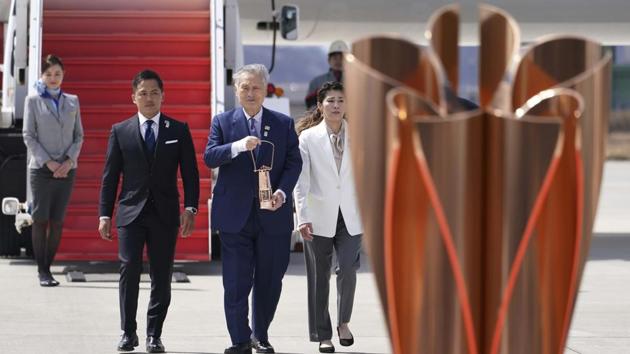 Tokyo 2020 Olympics chief Yoshiro Mori, center, followed by three-time Olympic gold medalists Tadahiro Nomura and Saori Yoshida, right, carries the Olympic flame during the Flame Arrival Ceremony at Japan Air Self-Defense Force Matsushima Base in Higashimatsushima (AP) Tokyo 2020 Olympics chief Yoshiro Mori, center, followed by three-time Olympic gold medalists Tadahiro Nomura and Saori Yoshida, right, carries the Olympic flame during the Flame Arrival Ceremony at Japan Air Self-Defense Force Matsushima Base in Higashimatsushima (AP)
