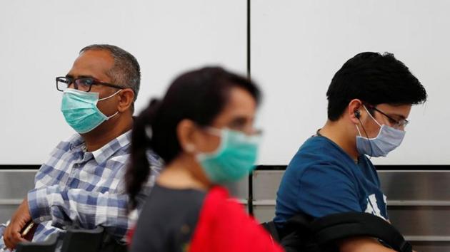 Coronavirus: Passengers wearing protective masks sit at an airport terminal following an outbreak of the coronavirus disease (COVID-19).(REUTERS) Coronavirus: Passengers wearing protective masks sit at an airport terminal following an outbreak of the coronavirus disease (COVID-19).(REUTERS)
