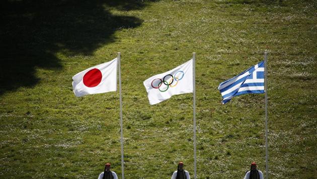 Greek Evzones guards stand next to Japan, Olympic and Greece flags (AP) Greek Evzones guards stand next to Japan, Olympic and Greece flags (AP)