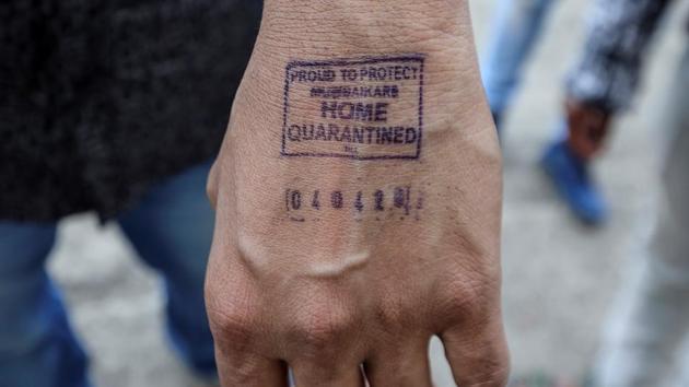 A man shows his hand -- stamped by airport authorities as he was advised for self quarantine due to international travel history amid rising coronavirus concerns in Mumbai. (Prashant Waydande / REUTERS)