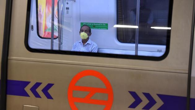 Commuters wearing face masks or with their faces generally covered as a precautionary measure against coronavirus infections, at Rajiv Chowk Metro Station in New Delhi, India, on Friday, March 20, 2020.(Raj K Raj/HT PHOTO)