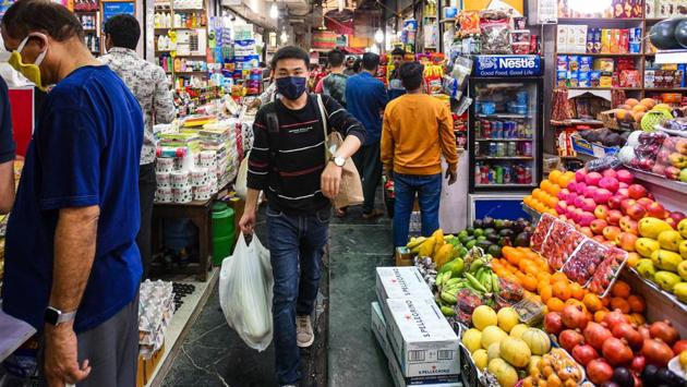 People in face masks throng to stock up on groceries amid a coronavirus fuelled panic at INA Market, in New Delhi. (Amal KS / HT Photo)