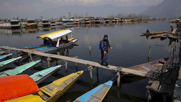 Municipal Corporation staff spray disinfectants on Shikaras as a precautionary measure against COVID-19 in Srinagar. The Jammu and Kashmir government on Tuesday banned entry of foreign tourists to Kashmir as a precautionary measure in view of the coronavirus. Uttarakhand, Himachal Pradesh, Sikkim and Nagaland have banned the entry all new tourists, both domestic and foreign. (Dar Yasin / AP)