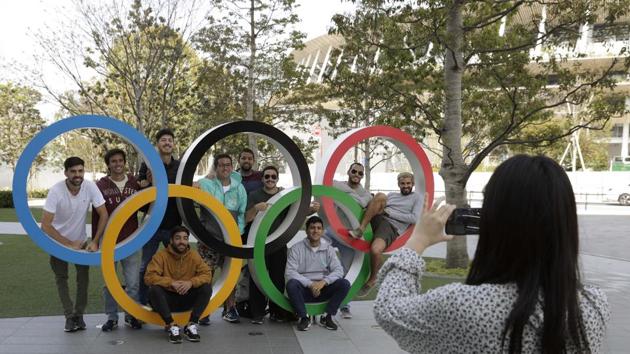 A group of students from Uruguay pose for a souvenir picture on the Olympic Rings set outside the Olympic Stadium in Tokyo. (AP) A group of students from Uruguay pose for a souvenir picture on the Olympic Rings set outside the Olympic Stadium in Tokyo. (AP)