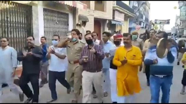 The screengrab from a video showing Pilibhit SM and SP leading a procession during Janta Curfew on Sunday.(Twitter)