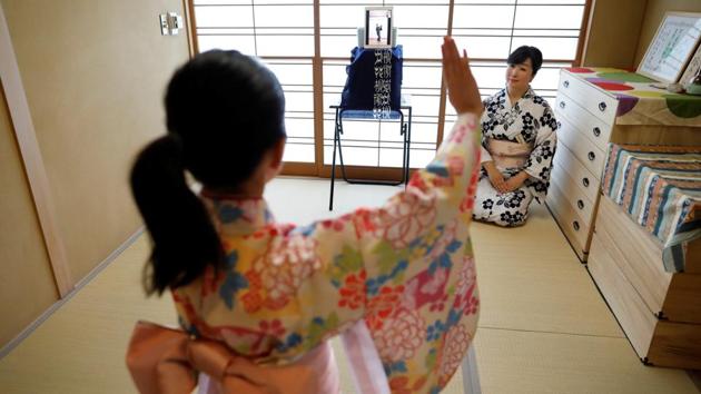 Komaki Yamashita, 49, and her daughter Konoha, 9, receive an online dance lesson by Takujiro Hanayagi, a Japanese traditional dancer, during the novel coronavirus disease (COVID-19) outbreak at their home in Tokyo, Japan. Konoha is staying at home while her school is closed. Although the family sometimes go out to a park, they don't want to travel by public transport so are taking the dance classes online. (REUTERS / Issei Kato )