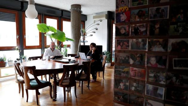 Corrando Tomassini, 49, and his wife Rosanna Maserati, 49, work from home in Milan, following the Italian authorities decision to close schools and universities . “I had never experienced this kind of continuative smart working before. Even if my company launched the smart working programme several years ago, I never took advantage of it because I found it easier to go to the office, which is close to where I live.” said Tomassini. (REUTERS / Guglielmo Mangiapane)