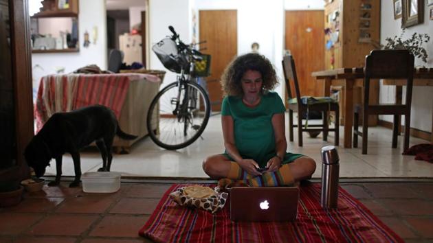 Ana Pereira, 51, uses her computer to go online and join a virtual picnic with her friends at her home, during the novel coronavirus outbreak, in Caracas, Venuzuela. When asked what she missed most while self isolating she said, “I want a hug, because you can talk to people but the physical contact is what I miss most.” (Manaure Quintero / REUTERS)