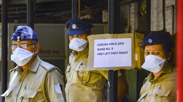 Security personnel wear masks to prevent the spread of coronavirus outside a special isolation ward at Kasturba Hospital, in Mumbai. (PTI)