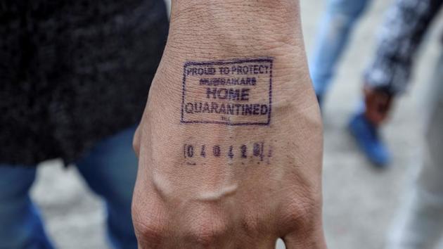 A man shows his hand which was stamped by airport authorities as he was advised for home quarantine after he arrived from overseas. (REUTERS)