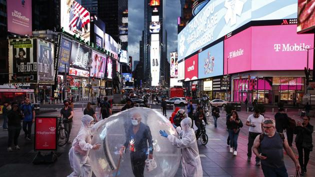 Artists perform under a billboard displaying thanks to healthcare workers due to COVID-19 concerns in a sparsely populated Times Square, in New York. In the US Congress, efforts to advance a nearly two-trillion-dollar rescue of the economy failed for a second straight day after Democrats said the Republican proposal insufficiently protected workers. (AP)