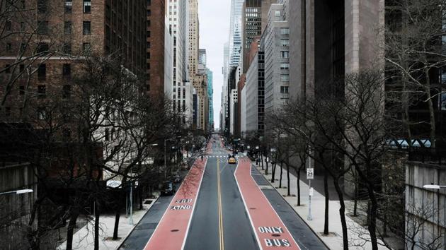Forty Second Street stands mostly empty as much of the city is void of cars and pedestrians over fears of spreading the coronavirus on March 22, 2020 in New York City. New York’s yellow cabs were out but passengers appeared few and far between with sidewalks virtually deserted. Underground, normally packed subway cars trundled along close to empty. (Spencer Platt / Getty Images / AFP)