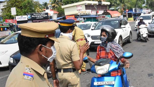 Police personnel, wearing protective masks, stop commuters during lockdown in the wake of novel coronavirus pandemic, in Kochi on Tuesday. (PTI) Police personnel, wearing protective masks, stop commuters during lockdown in the wake of novel coronavirus pandemic, in Kochi on Tuesday. (PTI)