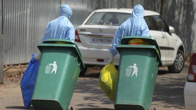 Workers walk with garbage after cleaning an isolation ward at a hospital for observing people suspected to have a new coronavirus infection in Kochi, Kerala, Tuesday, Feb.4, 2020. (AP File Photo) Workers walk with garbage after cleaning an isolation ward at a hospital for observing people suspected to have a new coronavirus infection in Kochi, Kerala, Tuesday, Feb.4, 2020. (AP File Photo)