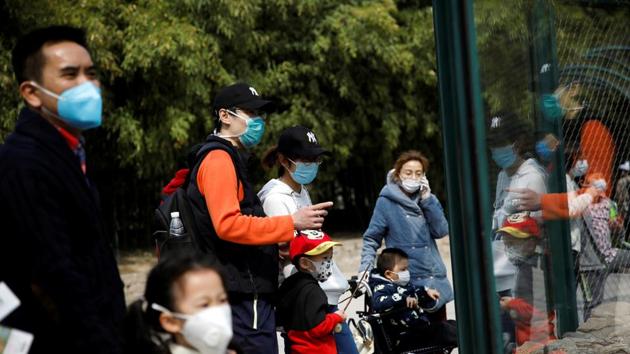 People wearing face masks visit Beijing Zoo, which has partially reopened after closing in late January due to the coronavirus disease (COVID-19) outbreak, in China, March 24, 2020.(REUTERS)