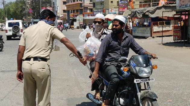 Police personnel taking action against people riding bikes on the road during the lockdown, in Maharashtra’ Kopergaon on Monday. (ANI Photo) Police personnel taking action against people riding bikes on the road during the lockdown, in Maharashtra’ Kopergaon on Monday. (ANI Photo)