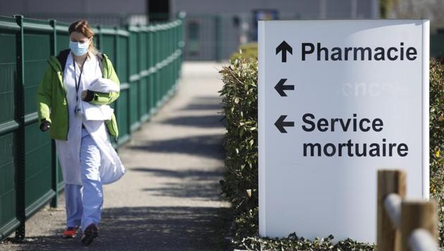 A medical staff walks by the civil hospital in Mulhouse, eastern France, Tuesday, March 24, 2020. The Grand Est region is now the epicenter of the outbreak in France, which has buried the third most virus victims in Europe, after Italy and Spain. For most people, the new coronavirus causes only mild or moderate symptoms. For some it can cause more severe illness. (AP) A medical staff walks by the civil hospital in Mulhouse, eastern France, Tuesday, March 24, 2020. The Grand Est region is now the epicenter of the outbreak in France, which has buried the third most virus victims in Europe, after Italy and Spain. For most people, the new coronavirus causes only mild or moderate symptoms. For some it can cause more severe illness. (AP)
