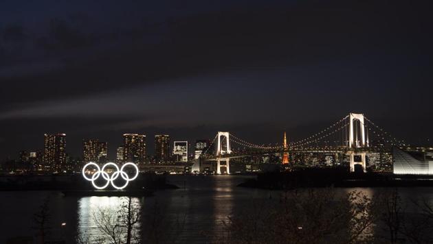 The Olympic rings float in the water near the Rainbow Bridge in the Odaiba section of Tokyo(AP)