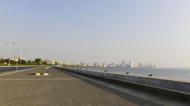 Crows line the Marine Drive promenade, gazing out to sea. The lockdown is the first time provisions of the National Disaster Management Act, 2005, are being invoked. This marks the first time, since the law came into being after the 2004 Tsunami that hit the eastern coast of India killing about 10,000 people, that the National Disaster Management Authority has invoked it. (Anshuman Poyrekar / HT Photo)