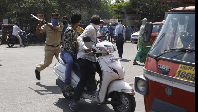 A police official seen caning an offender. (Rahul Raut/HT PHOTO) A police official seen caning an offender. (Rahul Raut/HT PHOTO)
