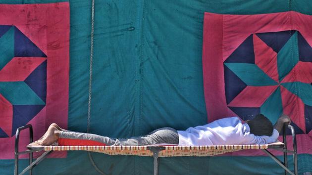 File photo of a man resting outside a relief camp for riot victims in Mustafabad, New Delhi. (HT File Photo) File photo of a man resting outside a relief camp for riot victims in Mustafabad, New Delhi. (HT File Photo)