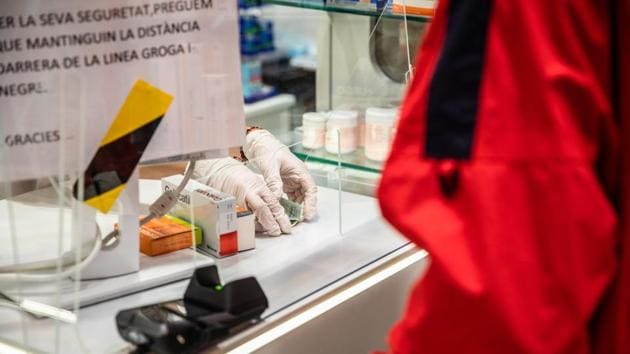 A pharmaceutical worker wears surgical gloves to serve a customer and handle cash in a pharmacy in Barcelona, Spain, on Sunday, March 15, 2020. Spain is declaring a state of emergency effective immediately for 15 days, significantly limiting mobility in the country as the government seeks to stop the expansion of the novel coronavirus, Prime Minister Pedro Sanchez said in televised speech Saturday. Photographer: Angel Garcia/Bloomberg (Bloomberg) A pharmaceutical worker wears surgical gloves to serve a customer and handle cash in a pharmacy in Barcelona, Spain, on Sunday, March 15, 2020. Spain is declaring a state of emergency effective immediately for 15 days, significantly limiting mobility in the country as the government seeks to stop the expansion of the novel coronavirus, Prime Minister Pedro Sanchez said in televised speech Saturday. Photographer: Angel Garcia/Bloomberg (Bloomberg)