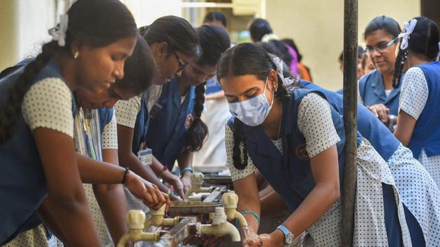 12th students wash their hands as a protective measure against the novel coronavirus pandemic, before entering an examination hall, at a school in Chennai. (PTI) 12th students wash their hands as a protective measure against the novel coronavirus pandemic, before entering an examination hall, at a school in Chennai. (PTI)