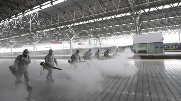 Firefighters disinfect the platform at Yichang East Railway Station in central China's Hubei Province. China is re-opening some train stations and bus service as it lifts the lockdown in Hubei province to stem the spread of the new coronavirus. The provincial railway group said that stations would open in all cities except Wuhan on Wednesday, the AP reported. (Wang Shen / Xinhua via AP)