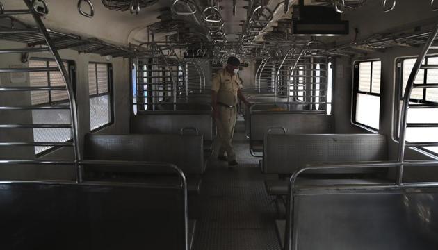 An Indian police officer wearing a mask checks a suburban train before they are locked down in Mumbai, India, Monday, March. 23, 2020. (AP photo) An Indian police officer wearing a mask checks a suburban train before they are locked down in Mumbai, India, Monday, March. 23, 2020. (AP photo)