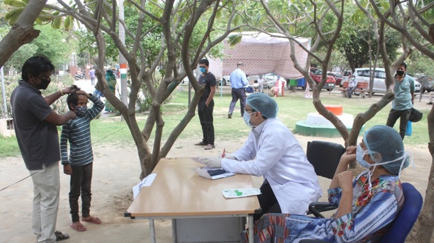 Doctors in protective clothing at Civil Hospital in Gurugram’s Sector 10 have come out of the hospital out in the open to see regular patients.(Yogendra Kumar/HT PHOTO)