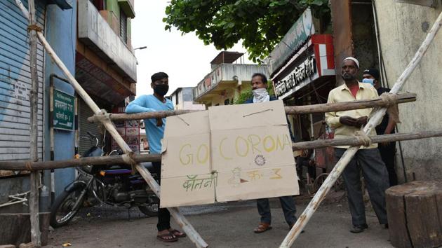 Logs of wood have been used as barricades at entry and exit points with boards stating ‘goan bandh’ or village closed. (HT PHOTO) Logs of wood have been used as barricades at entry and exit points with boards stating ‘goan bandh’ or village closed. (HT PHOTO)
