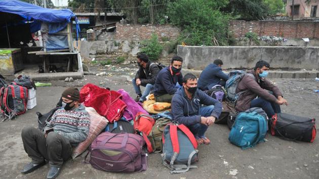 Stranded travellers wait for public transport in Jammu. With rail and interstate bus services suspended, migrant workers and daily wage labourers face uncertainty over being able to return to their villages and towns or being able to afford food and shelter without work in the coming weeks. (Nitin Kanotra / HT Photo) Stranded travellers wait for public transport in Jammu. With rail and interstate bus services suspended, migrant workers and daily wage labourers face uncertainty over being able to return to their villages and towns or being able to afford food and shelter without work in the coming weeks. (Nitin Kanotra / HT Photo)
