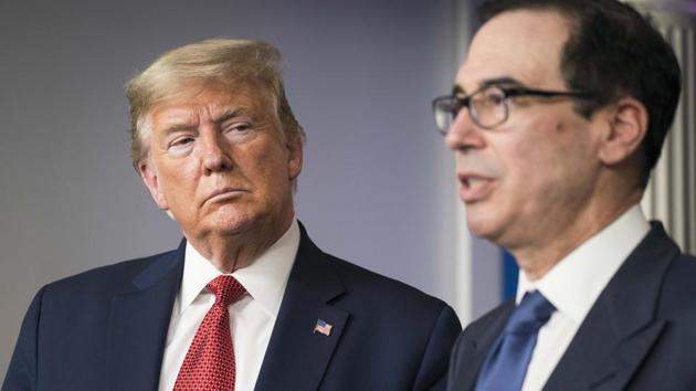 U.S. President Donald Trump, left, listens as Steven Mnuchin, U.S. Treasury secretary, speaks during a news conference in the Brady Press Briefing Room at the White House in Washington, D.C., U.S., on Wednesday, March 25, 2020.(Bloomberg)