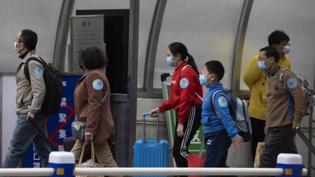 Returnees from the Hubei Province leave from the West Train Station to board buses in Beijing. (AP) Returnees from the Hubei Province leave from the West Train Station to board buses in Beijing. (AP)