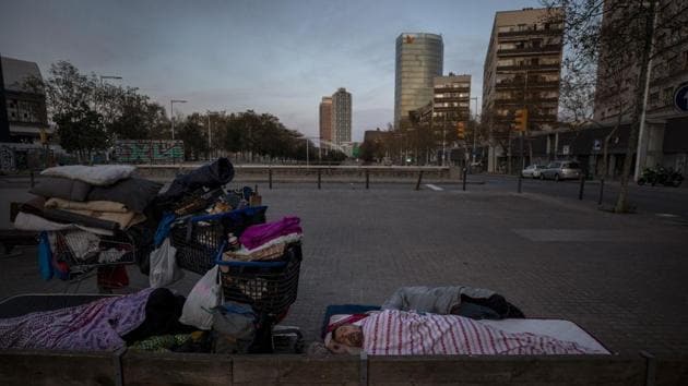 Boris, 42, from Bulgaria, sleeps under a blanket in the street in Barcelona, Spain. While Spanish authorities tell the public that staying home is the best way to beat the coronavirus pandemic, some people are staying out because home has come to mean the streets of Madrid and Barcelona. (Emilio Morenatti / AP) Boris, 42, from Bulgaria, sleeps under a blanket in the street in Barcelona, Spain. While Spanish authorities tell the public that staying home is the best way to beat the coronavirus pandemic, some people are staying out because home has come to mean the streets of Madrid and Barcelona. (Emilio Morenatti / AP)