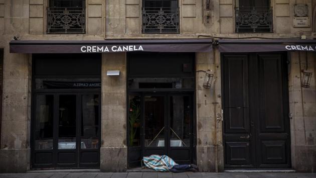 Jose sleeps in the street in downtown Barcelona, Spain. Jose, 27, has been sleeping in the street for 5 years and is convinced that the Spanish army will put all the beggars of the city in tents “I refuse! I am not going to be infested with the virus anywhere, I am safe here in the arcade,” he said. (Emilio Morenatti / AP) Jose sleeps in the street in downtown Barcelona, Spain. Jose, 27, has been sleeping in the street for 5 years and is convinced that the Spanish army will put all the beggars of the city in tents “I refuse! I am not going to be infested with the virus anywhere, I am safe here in the arcade,” he said. (Emilio Morenatti / AP)