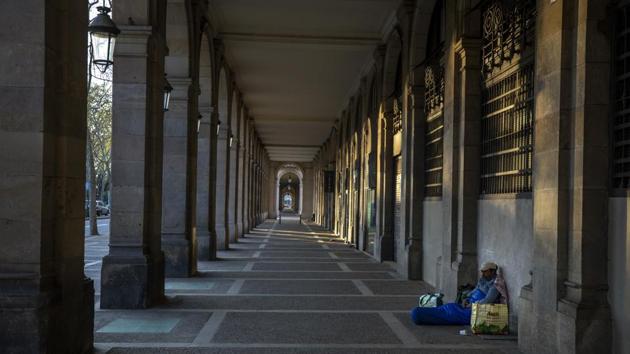 Riccardo, 32, sits in an empty arcade that overlooks Las Ramblas, the pedestrian avenue that is a Barcelona landmark. “I thought I had seen everything during all these years sleeping in the street, but no. This silence on the street all day scares me... more than the virus itself ...” said Riccardo, 32, who has been sleeping on the street for more than 10 years. (Emilio Morenatti / AP) Riccardo, 32, sits in an empty arcade that overlooks Las Ramblas, the pedestrian avenue that is a Barcelona landmark. “I thought I had seen everything during all these years sleeping in the street, but no. This silence on the street all day scares me... more than the virus itself ...” said Riccardo, 32, who has been sleeping on the street for more than 10 years. (Emilio Morenatti / AP)