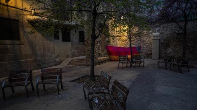A blanket is used as a shelter in the corner of a square in downtown Barcelona. With Spain one of the world's worst-hit countries by the new coronavirus, and the government ordering a national lockdown, the country's streets are largely deserted. Authorities are scrambling to get as many homeless people off the streets without cramming them into a group shelter, where the risk of getting infected could be even greater. (Emilio Morenatti / AP) A blanket is used as a shelter in the corner of a square in downtown Barcelona. With Spain one of the world's worst-hit countries by the new coronavirus, and the government ordering a national lockdown, the country's streets are largely deserted. Authorities are scrambling to get as many homeless people off the streets without cramming them into a group shelter, where the risk of getting infected could be even greater. (Emilio Morenatti / AP)