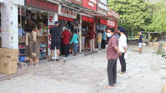 Mindful of social distancing, customers waiting for their turn to buy medicines at chemist shops in Phase 3B2, Mohali, on Thursday.(Gurminder Singh/HT)