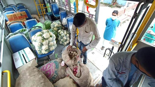 Administration staff organising vegetables for door-to-door delivery on a CTU bus at Sector 41 in Chandigarh on Thursday.(Keshav Singh/HT) Administration staff organising vegetables for door-to-door delivery on a CTU bus at Sector 41 in Chandigarh on Thursday.(Keshav Singh/HT)