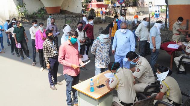 People maintain social distance as they stand in a queue to collect passes for essential services during day-2 of a nationwide lockdown, imposed in the wake of coronavirus pandemic, in Nagpur, Thursday, March 26, 2020. (PTI photo) People maintain social distance as they stand in a queue to collect passes for essential services during day-2 of a nationwide lockdown, imposed in the wake of coronavirus pandemic, in Nagpur, Thursday, March 26, 2020. (PTI photo)