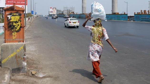 A woman holding a packet on her head walks past the Western Express highway on the second day of the lockdown in Mumbai. More than half of these 13 million migrated out of just three states – Uttar Pradesh, Bihar and Rajasthan. More than half went to four states – Maharashtra, Delhi, Gujarat and Karnataka, primary driven to urban clusters such as Mumbai, Ahmedabad and Bengaluru. (ANI)