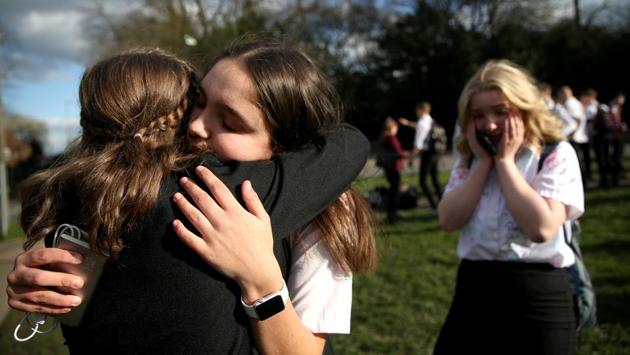 Georgia Mayer, aged 16, bids goodbye to her friends at a school in Newcastle-under-Lyme as the majority of schools in the UK shut. (CArl Recine / REUTERS) Georgia Mayer, aged 16, bids goodbye to her friends at a school in Newcastle-under-Lyme as the majority of schools in the UK shut. (CArl Recine / REUTERS)